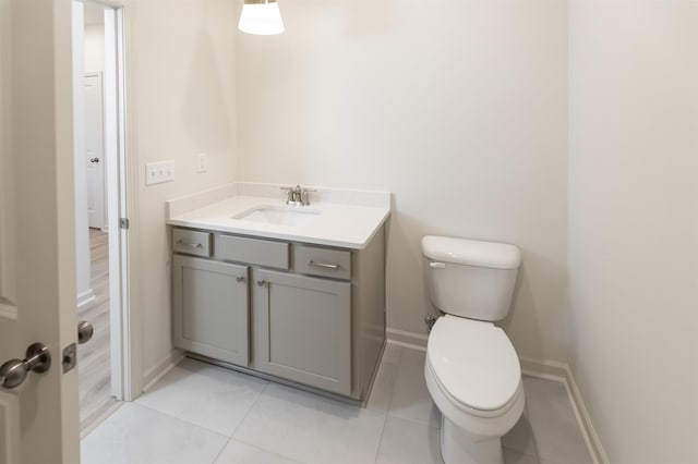 bathroom with tile patterned flooring, vanity, and toilet