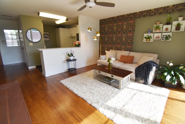 living room featuring ceiling fan and hardwood / wood-style floors