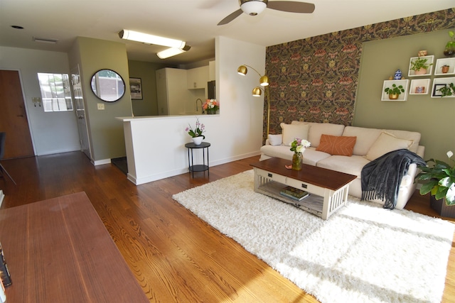 living room with ceiling fan, dark hardwood / wood-style floors, and sink