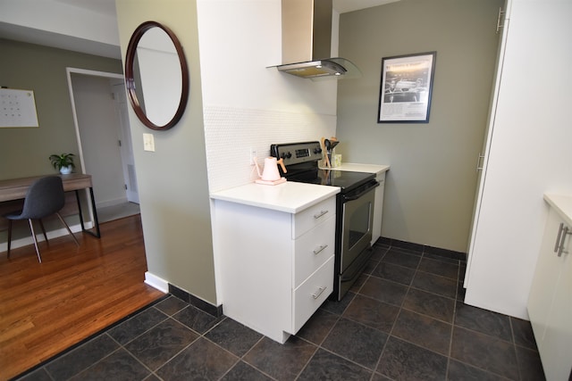 kitchen with wall chimney exhaust hood, tasteful backsplash, dark tile flooring, and electric range