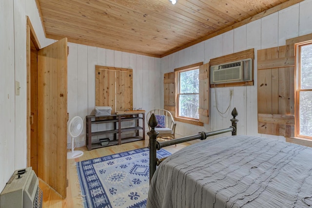 bedroom featuring wooden walls, wooden ceiling, and light wood-type flooring