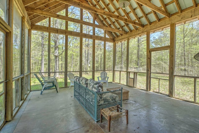 unfurnished sunroom with vaulted ceiling with beams and plenty of natural light