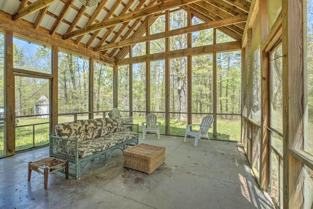 unfurnished sunroom featuring vaulted ceiling