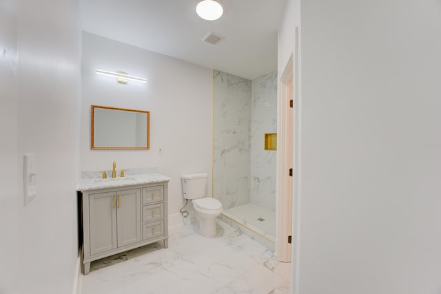 bathroom with toilet, tile flooring, vanity, and a tile shower