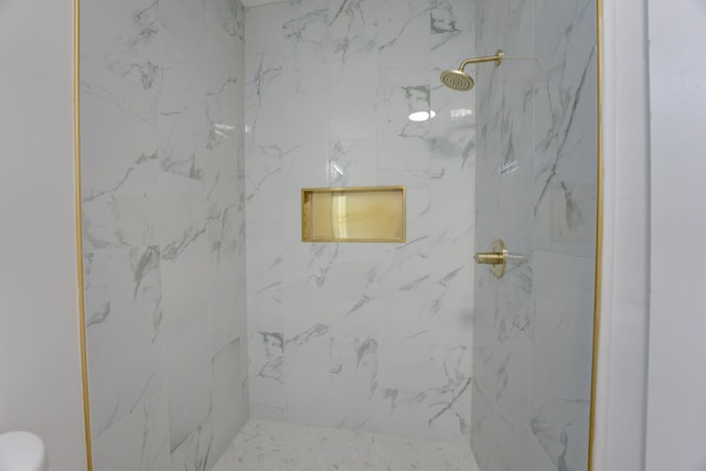 bathroom with tiled shower