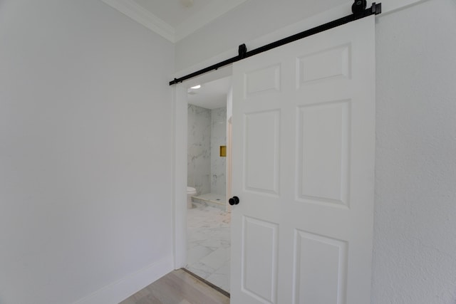 bathroom with crown molding, wood-type flooring, and toilet