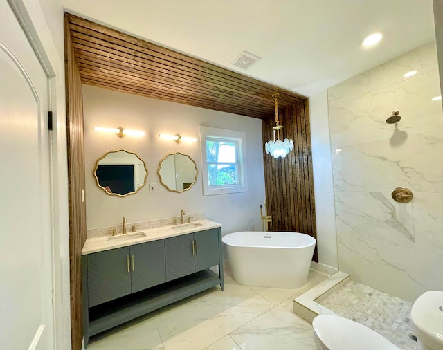 bathroom featuring tile floors, toilet, a tile shower, and double vanity