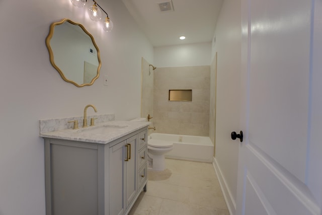 full bathroom featuring vanity, toilet, tile floors, and tiled shower / bath combo