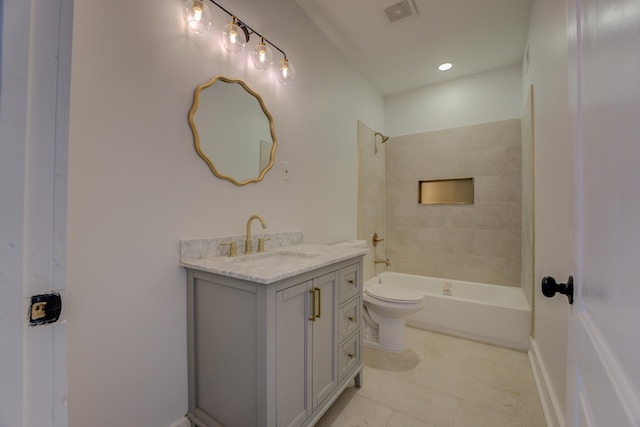 full bathroom with tiled shower / bath, toilet, tile flooring, and vanity