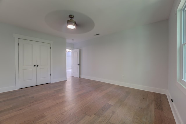 spare room with hardwood / wood-style flooring and ceiling fan