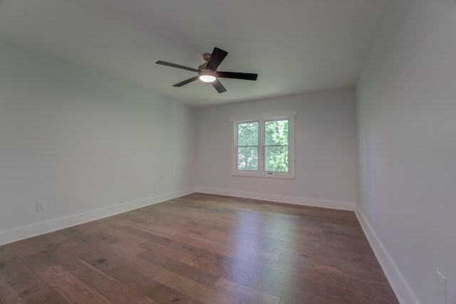 spare room featuring ceiling fan and dark wood-type flooring