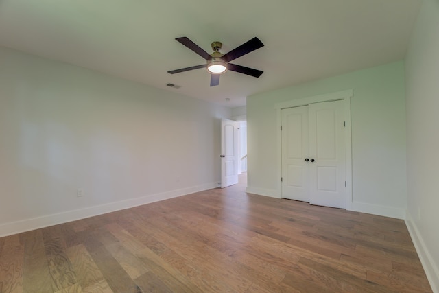 spare room featuring hardwood / wood-style flooring and ceiling fan