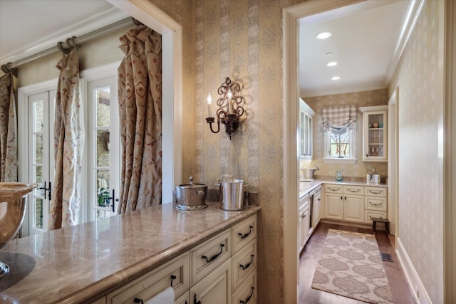 bathroom with wood-type flooring, a wealth of natural light, vanity, and crown molding