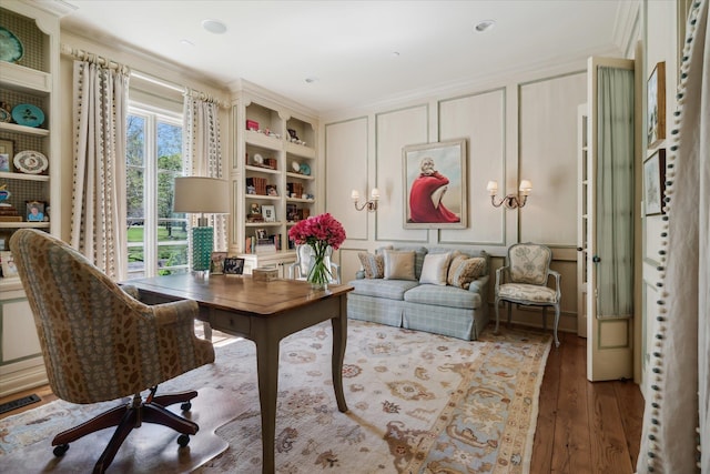 office area featuring hardwood / wood-style floors and ornamental molding