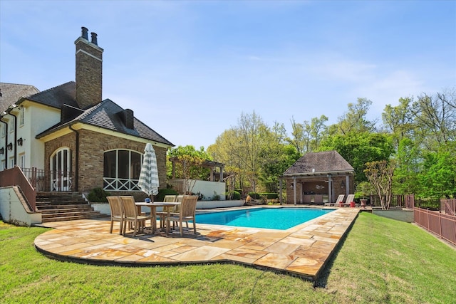 view of pool featuring a patio area and a lawn