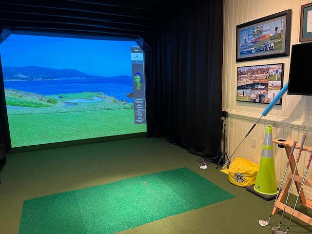 recreation room featuring a mountain view, carpet flooring, and golf simulator