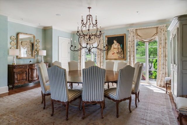 dining area with a healthy amount of sunlight, wood-type flooring, and a notable chandelier