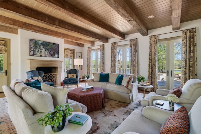 living room featuring french doors, a healthy amount of sunlight, wood ceiling, and beamed ceiling