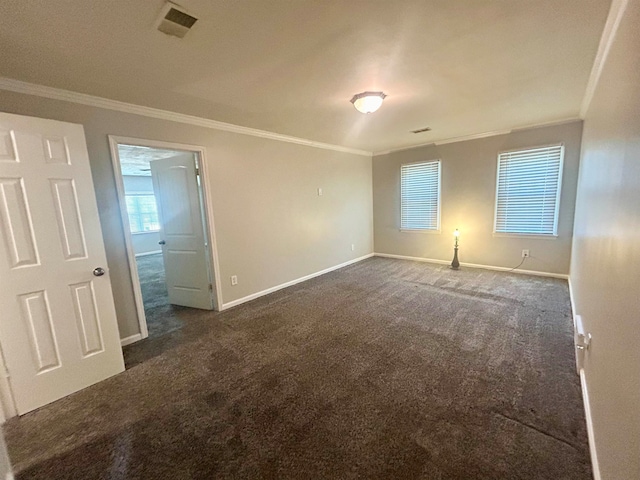 carpeted empty room featuring crown molding