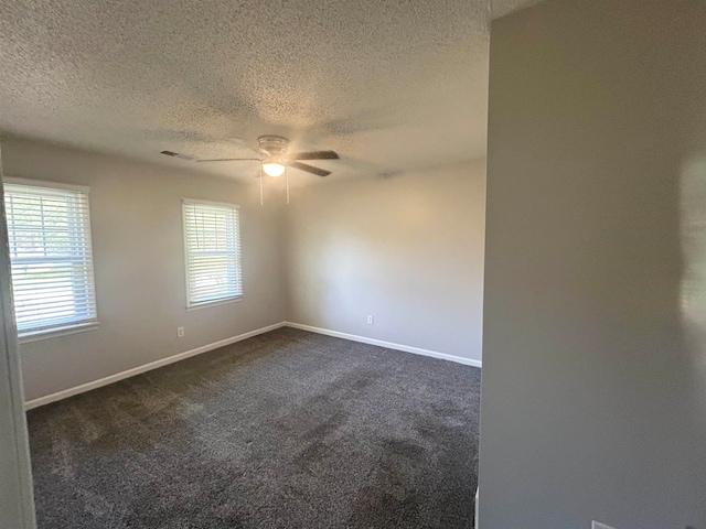 carpeted spare room with ceiling fan and a textured ceiling