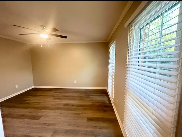 empty room with ceiling fan, ornamental molding, and dark wood-type flooring