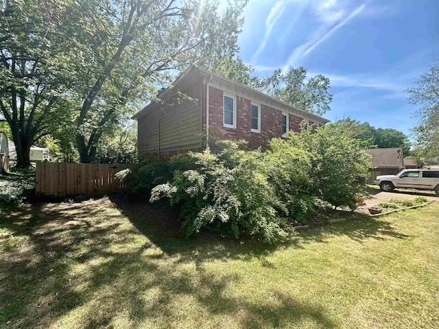 view of property exterior with a yard