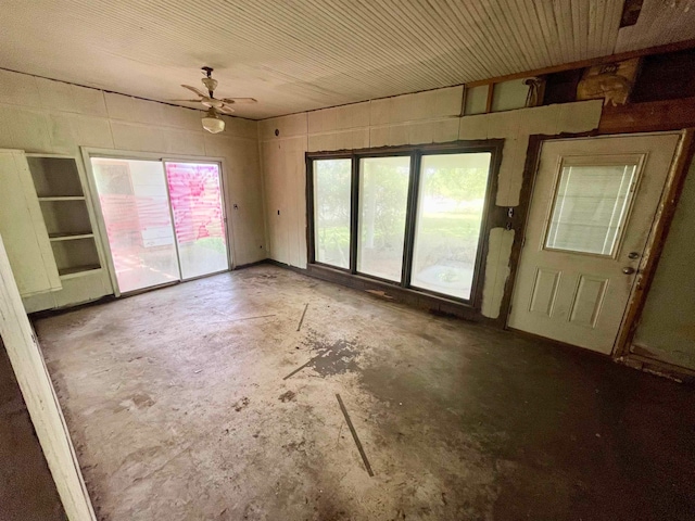 spare room featuring concrete floors and ceiling fan