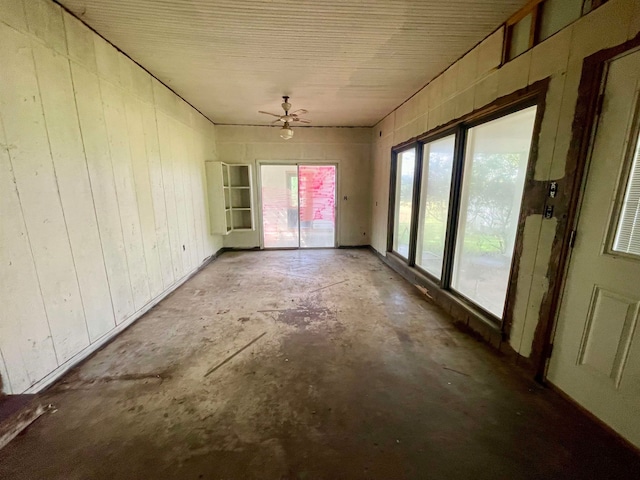 unfurnished sunroom featuring ceiling fan