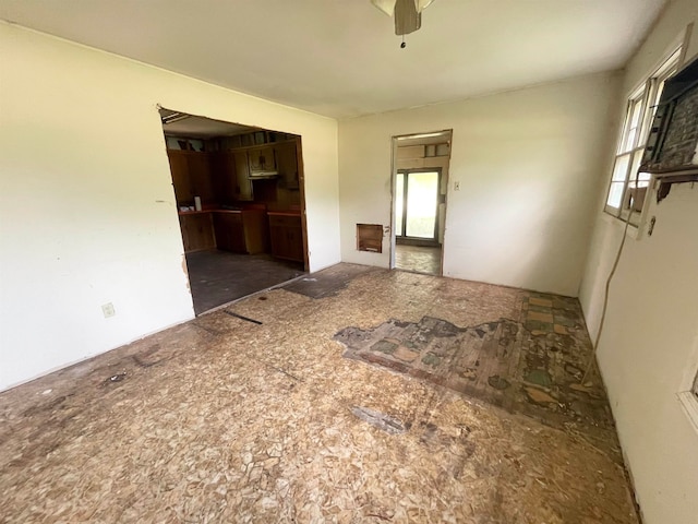 spare room with a healthy amount of sunlight and ceiling fan