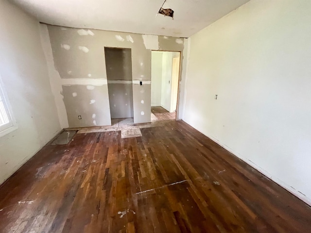 unfurnished room with wood-type flooring