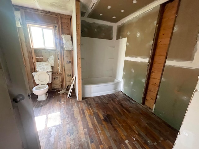 bathroom with toilet and hardwood / wood-style flooring