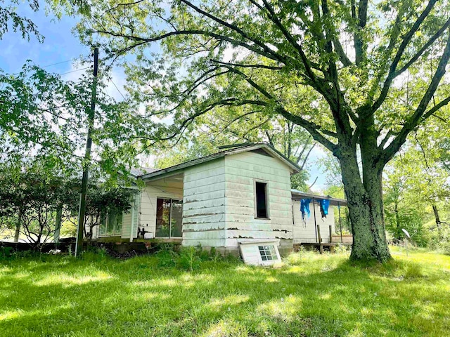 view of home's exterior with a yard