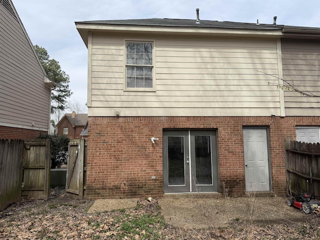 back of house with fence and brick siding