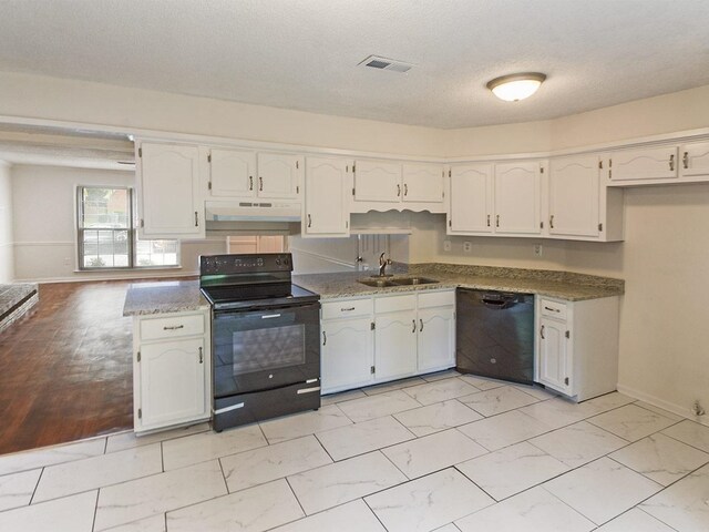 kitchen featuring visible vents, marble finish floor, black appliances, under cabinet range hood, and a sink