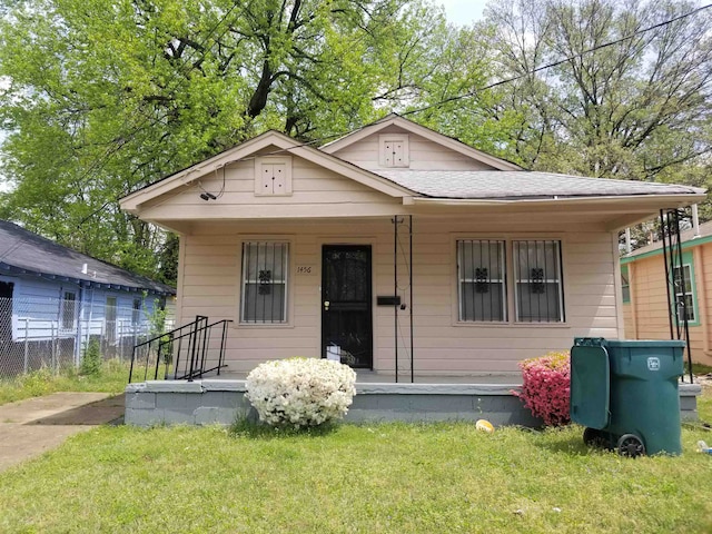 bungalow-style home with a front lawn