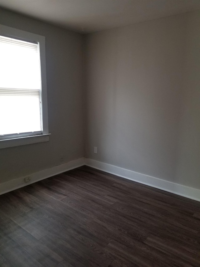 spare room with dark hardwood / wood-style flooring