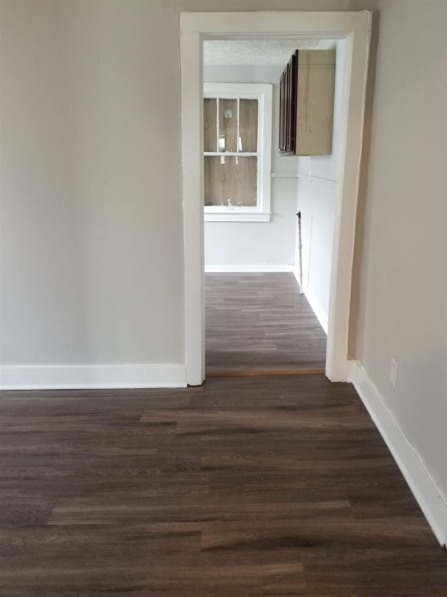 corridor with dark hardwood / wood-style floors