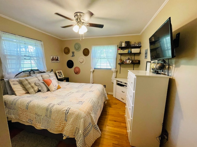 bedroom featuring crown molding, ceiling fan, and light hardwood / wood-style floors