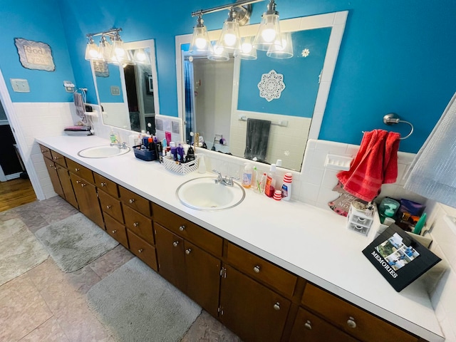 bathroom with tile patterned flooring, vanity, and backsplash