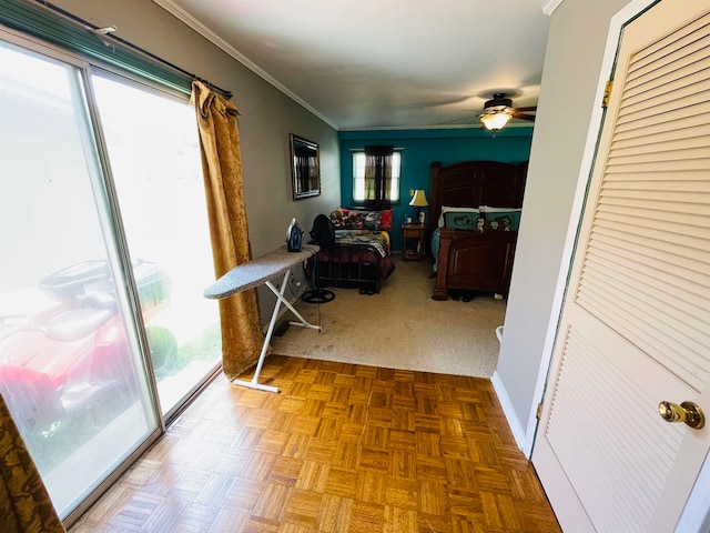 living room featuring parquet floors, crown molding, and ceiling fan