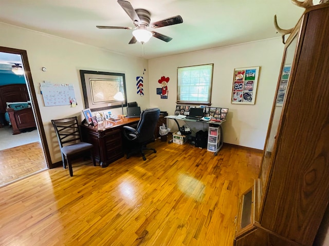 office space with light wood-type flooring and ceiling fan