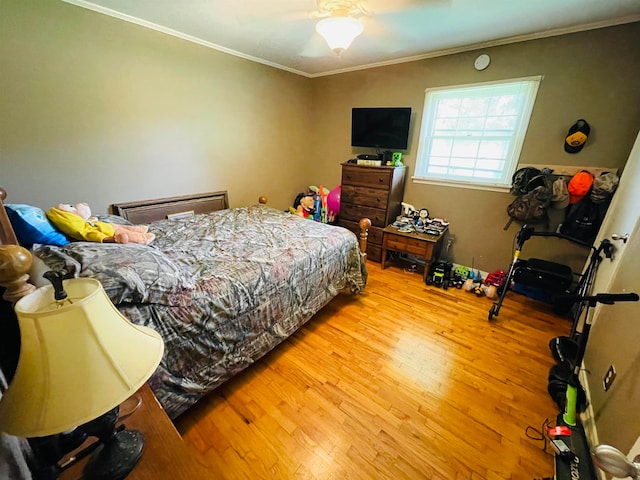 bedroom with ceiling fan, ornamental molding, and hardwood / wood-style floors