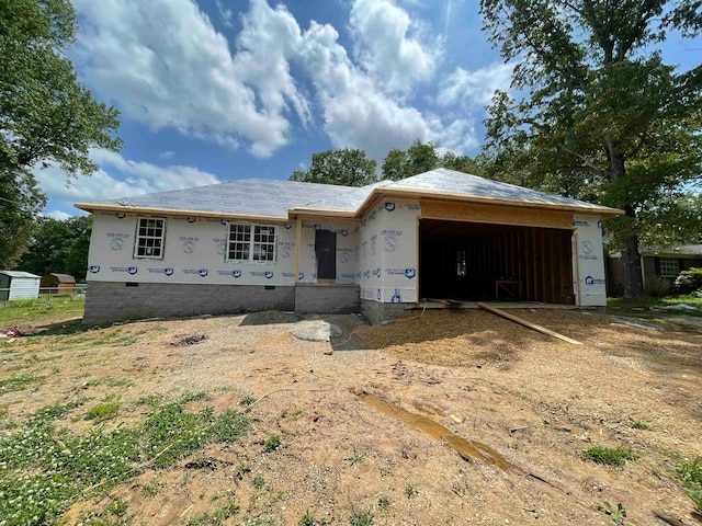 unfinished property with an outbuilding and a garage