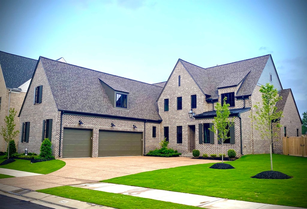 view of front of home with a garage and a front yard