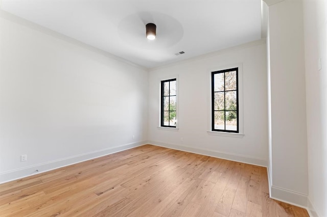 unfurnished room with light hardwood / wood-style flooring and crown molding