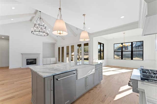 kitchen featuring gray cabinets, light hardwood / wood-style flooring, dishwasher, and decorative light fixtures