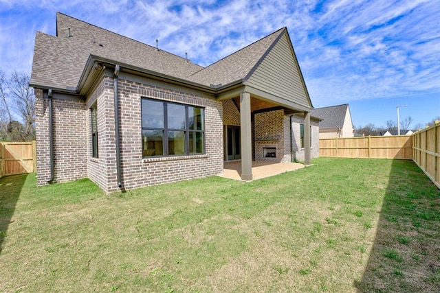 rear view of house featuring a patio and a yard