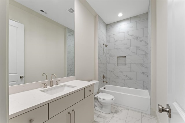 full bathroom featuring tiled shower / bath combo, vanity, toilet, and tile flooring