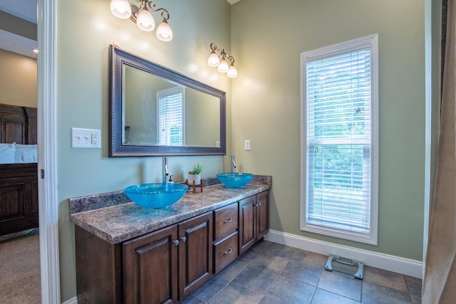 bathroom with large vanity, dual sinks, and tile flooring