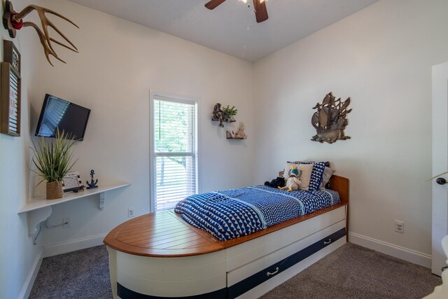 bedroom featuring dark colored carpet and ceiling fan